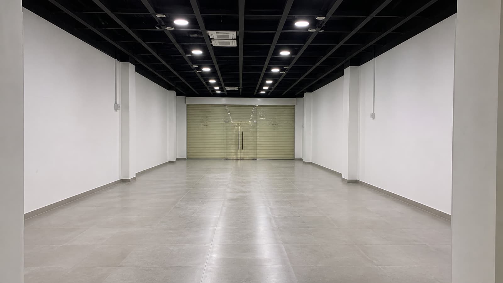 A cleaned, empty retail lot with lighting on, ready for handback.