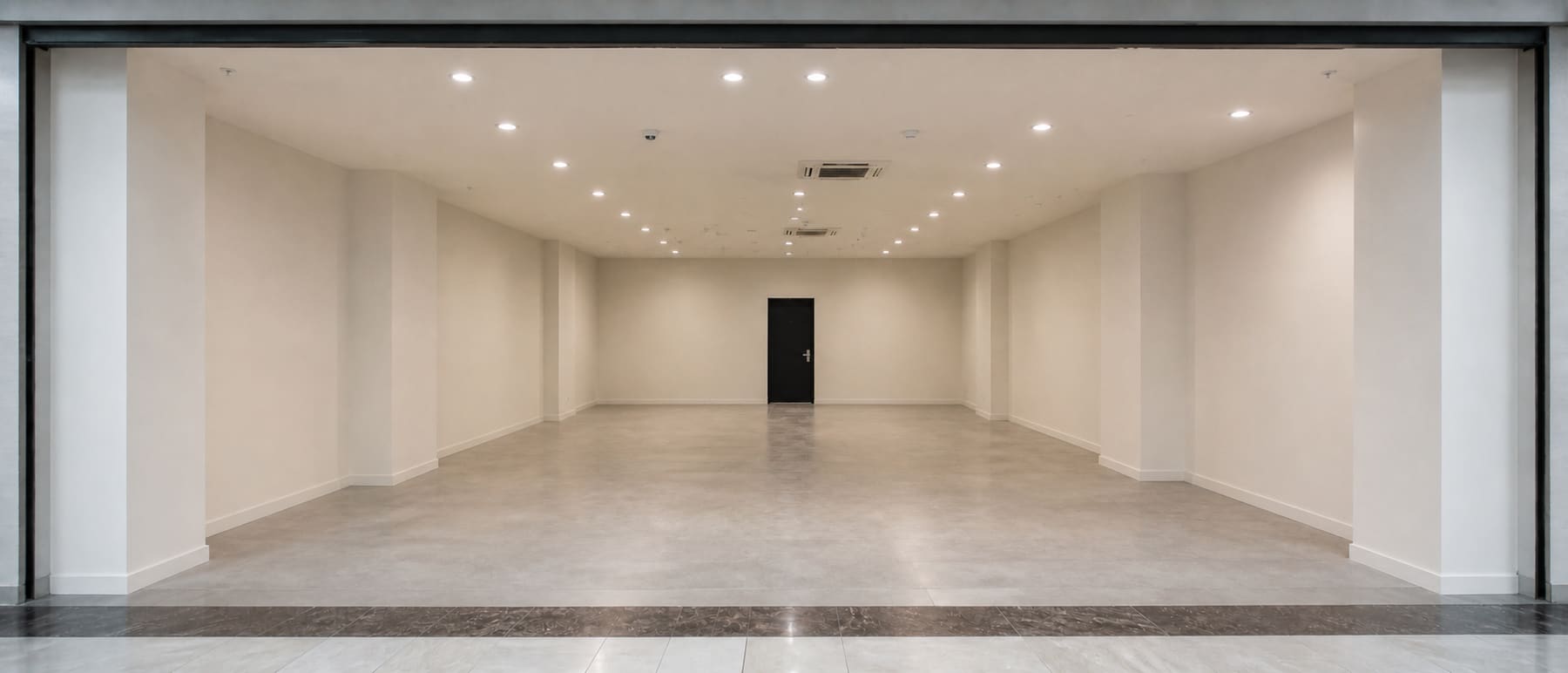 The same shopping mall retail unit cleared to a clean bare condition after tenancy restoration.